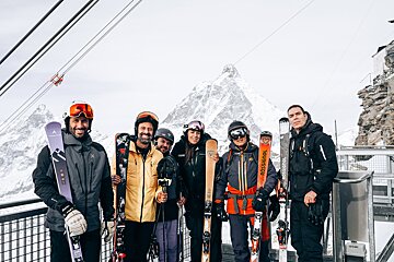 A group of people holding skis that say rossignol