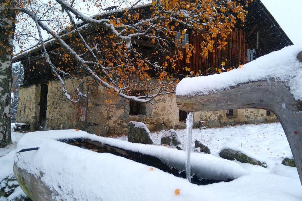 Chalet and water trough in the snow at Charousse near Chamonix