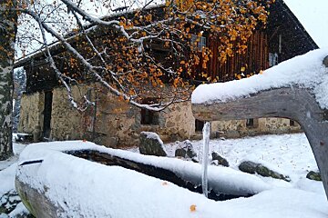 Chalet and water trough in the snow at Charousse near Chamonix