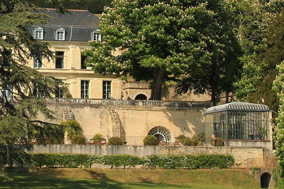 A large building with a greenhouse in front of it
