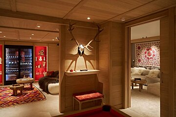 A room with a pool table and antlers on the wall