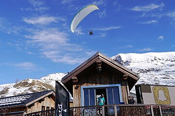 a paraglider over the roof