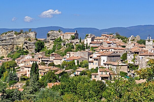 a provence village next to some cliffs