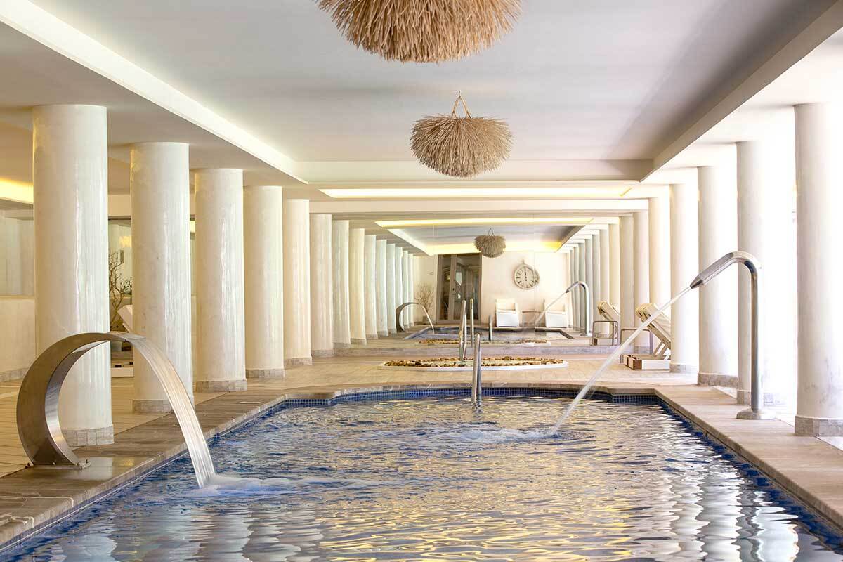 A swimming pool with a waterfall in the middle of it