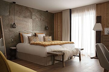 A bedroom with a bed and a yellow couch