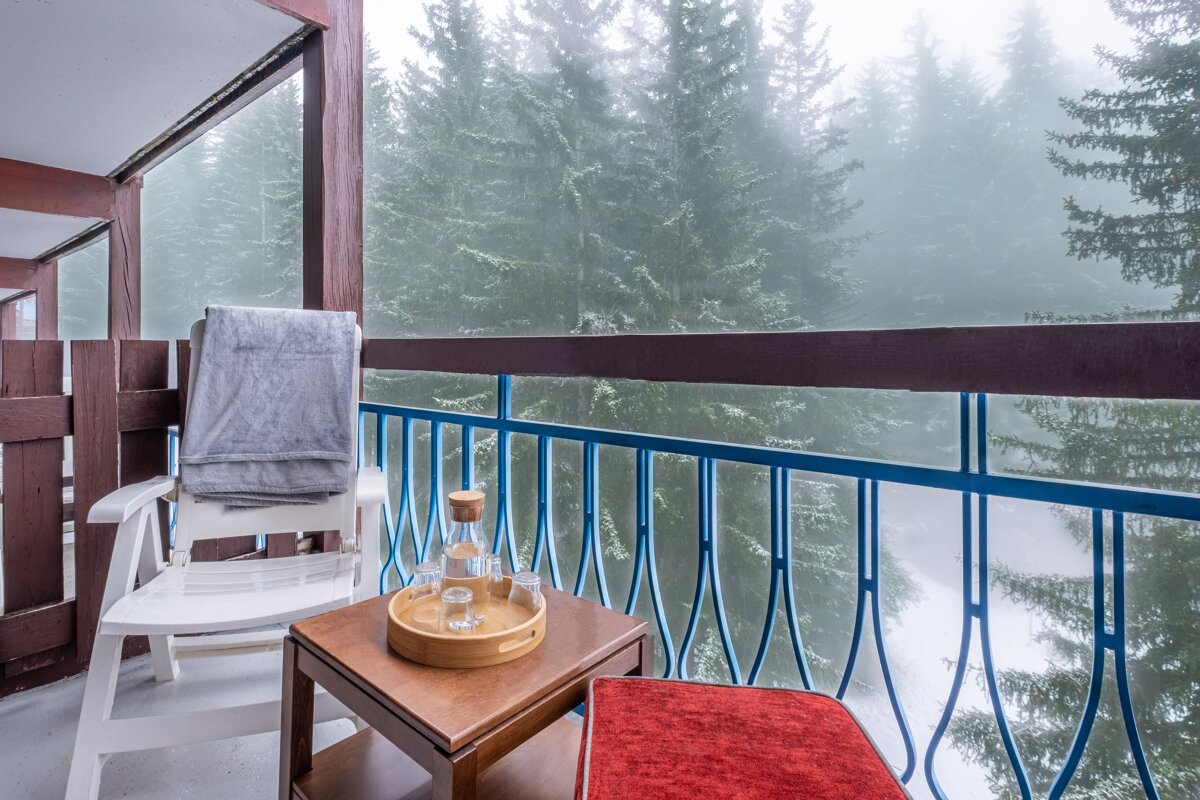 A balcony with a chair and a tray on it