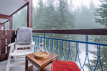 A balcony with a chair and a tray on it