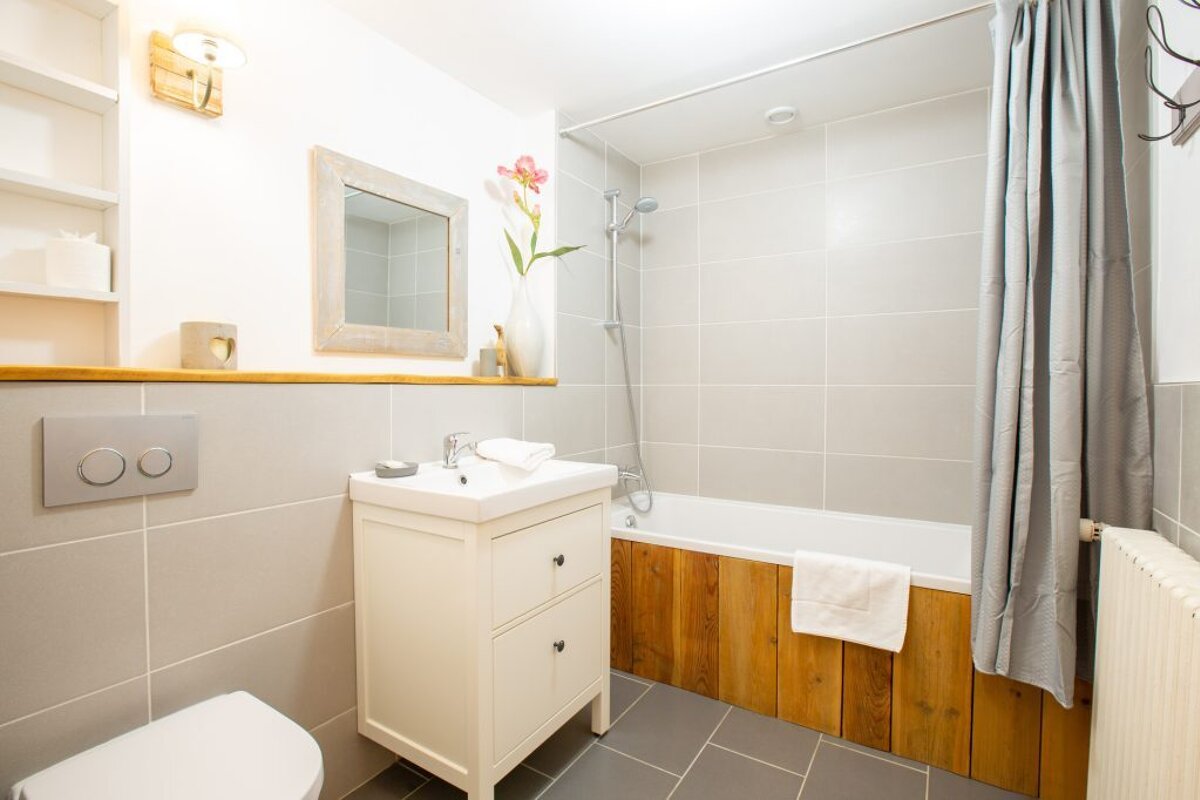 A bathroom with a sink toilet and bathtub