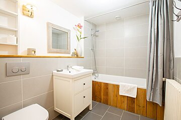 A bathroom with a sink toilet and bathtub