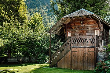 A wooden building with a staircase leading up to it