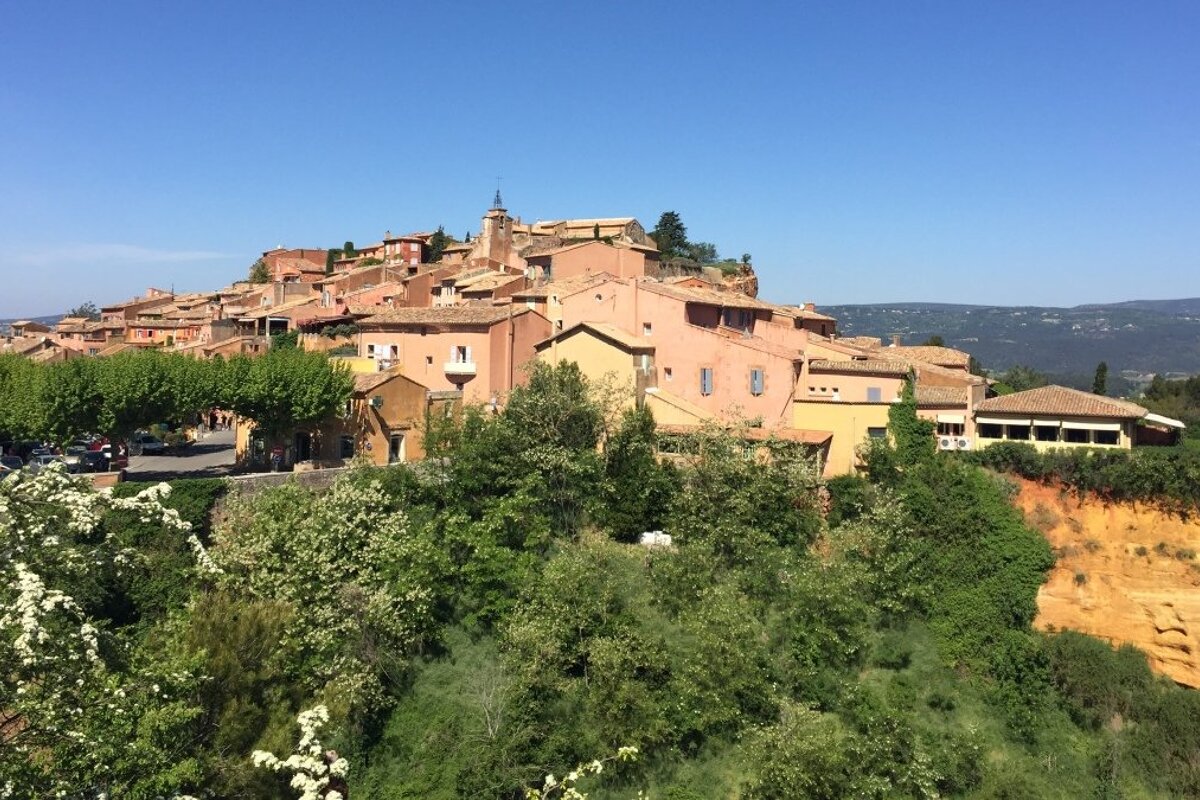 a hilltop village with ochre cliffs in provence