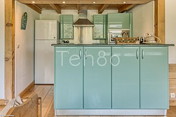 A kitchen with teh80 written on the cabinets