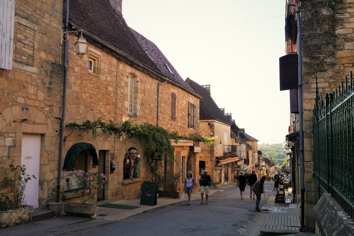 people on the grand rue street in domme