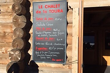 a menu board outside a mountain restaurant