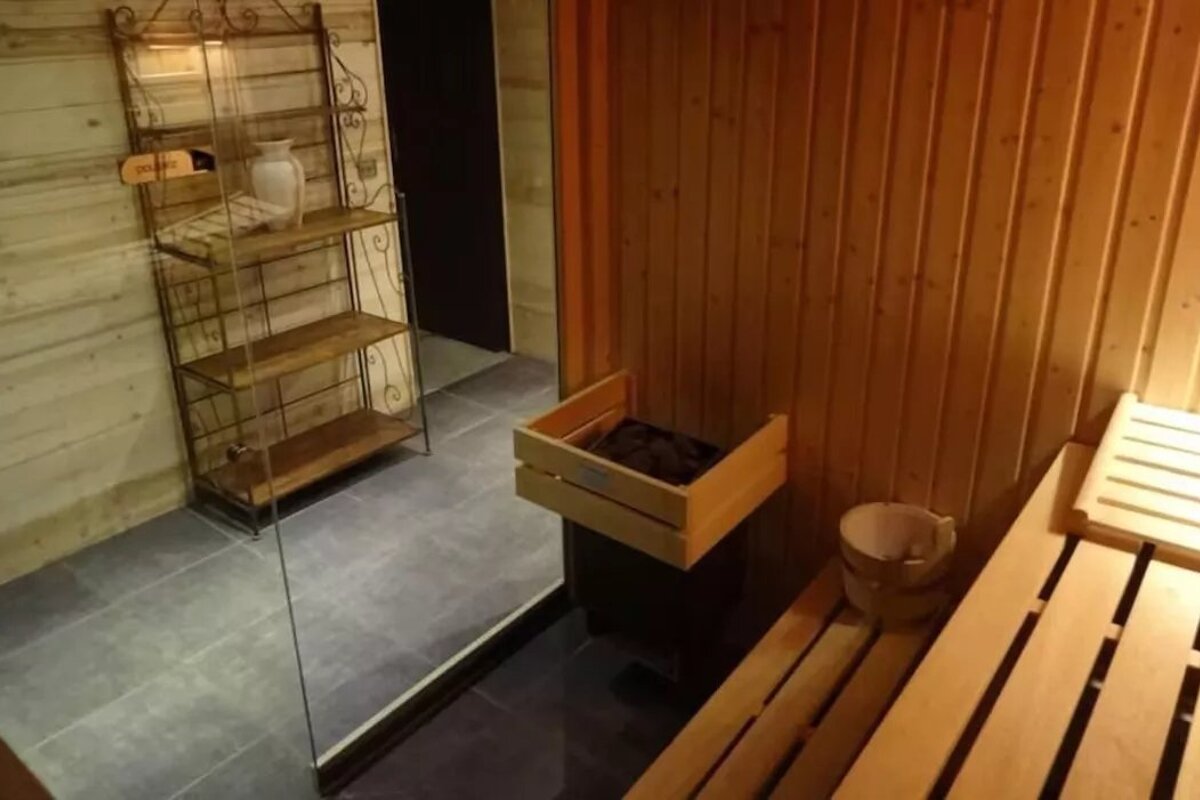 A wooden box in a sauna with a sign that says ' finland ' on it