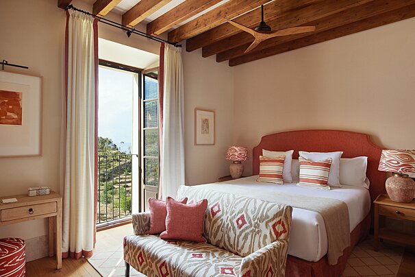 A bedroom with a large bed and a window