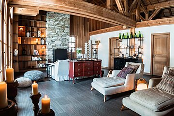 A living room with lots of furniture and candles
