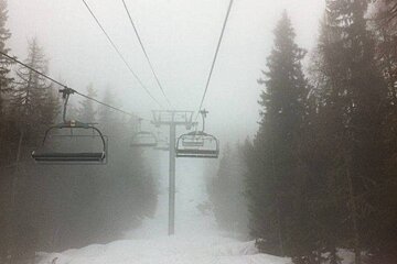 a chair lift in the fog