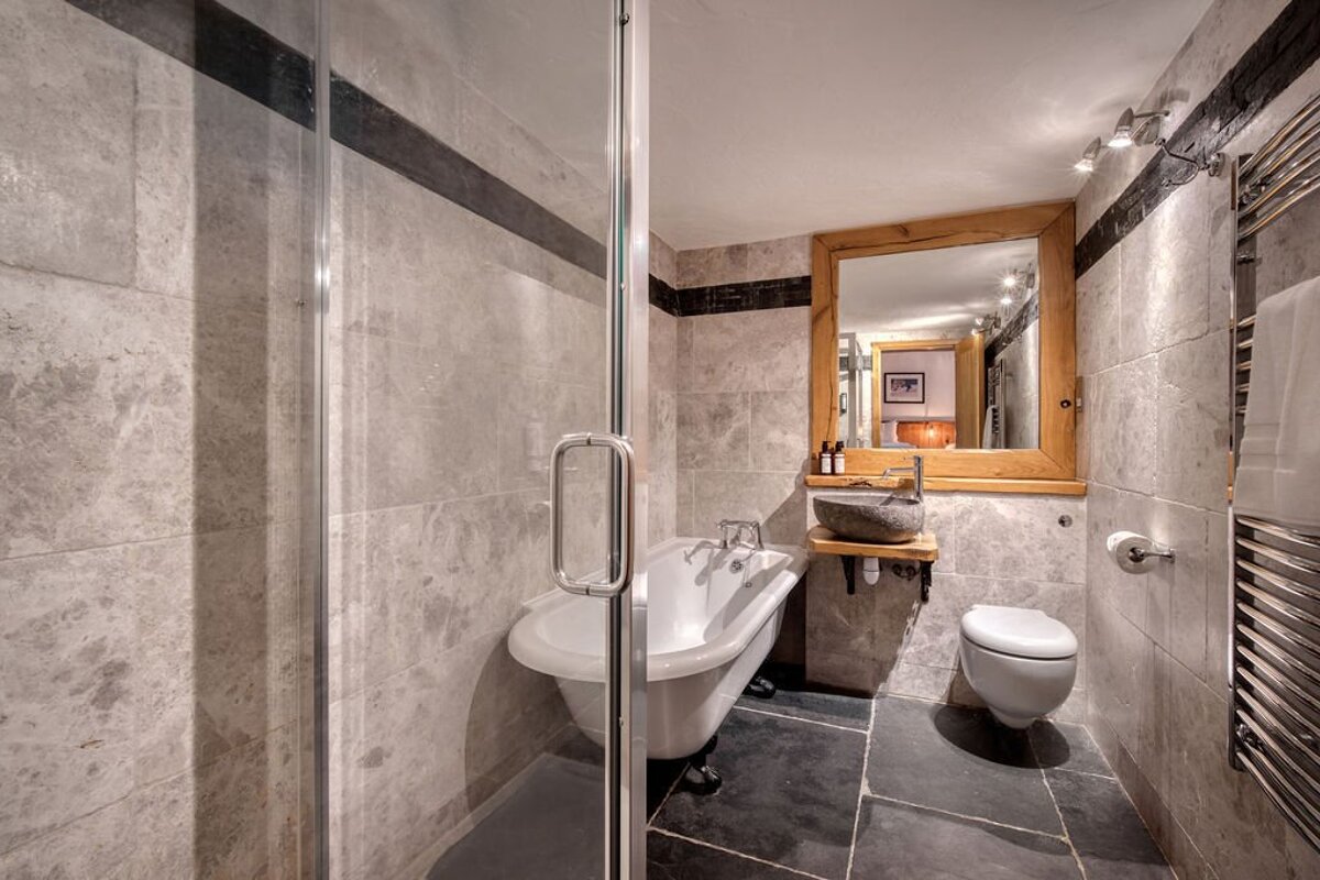 A bathroom with a claw foot tub and a toilet