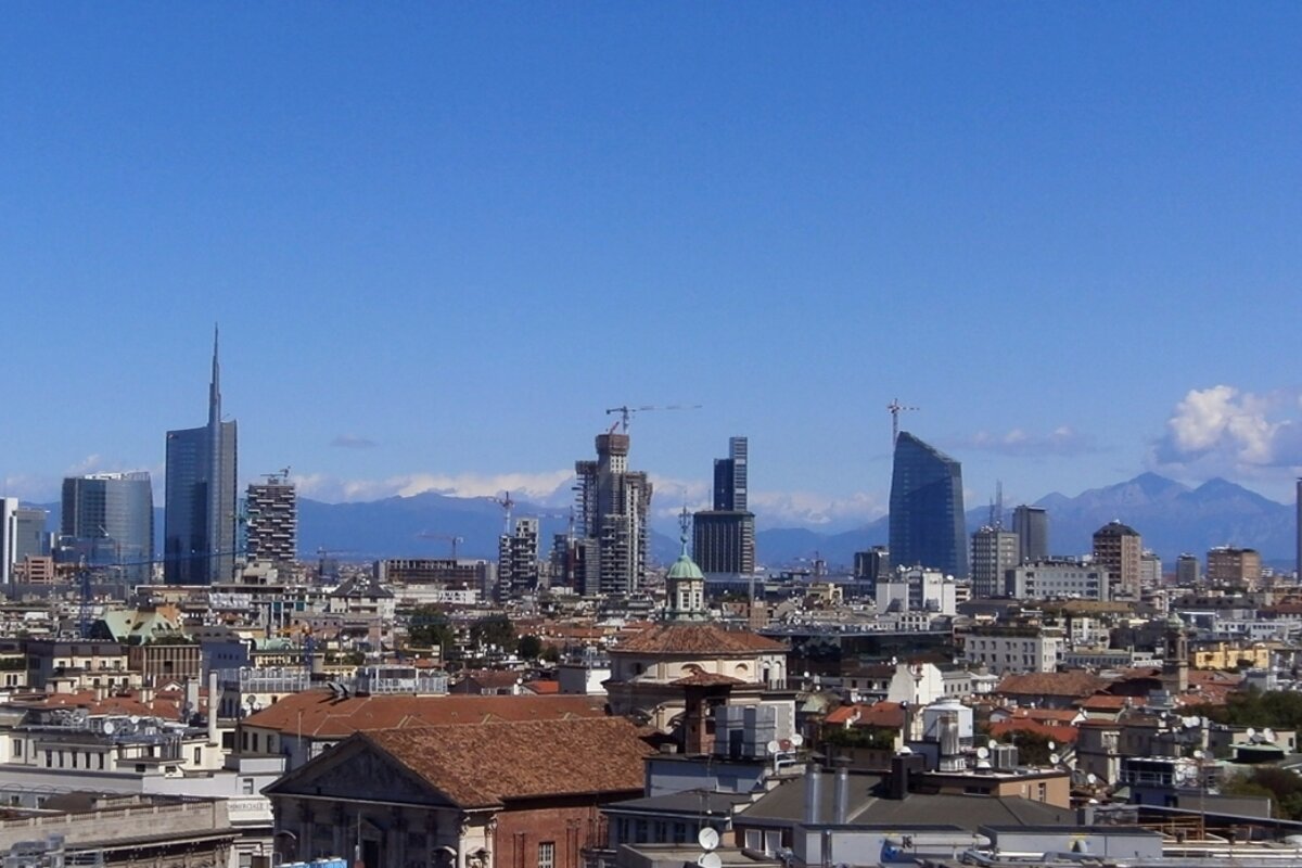 An aerial view of a city with mountains in the background