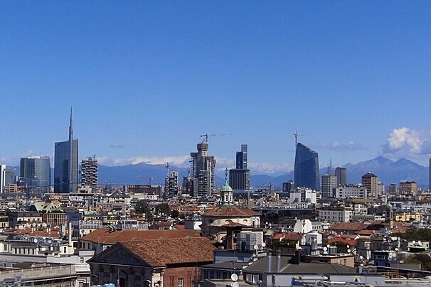 An aerial view of a city with mountains in the background