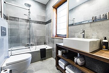 A bathroom with a toilet a sink and a window