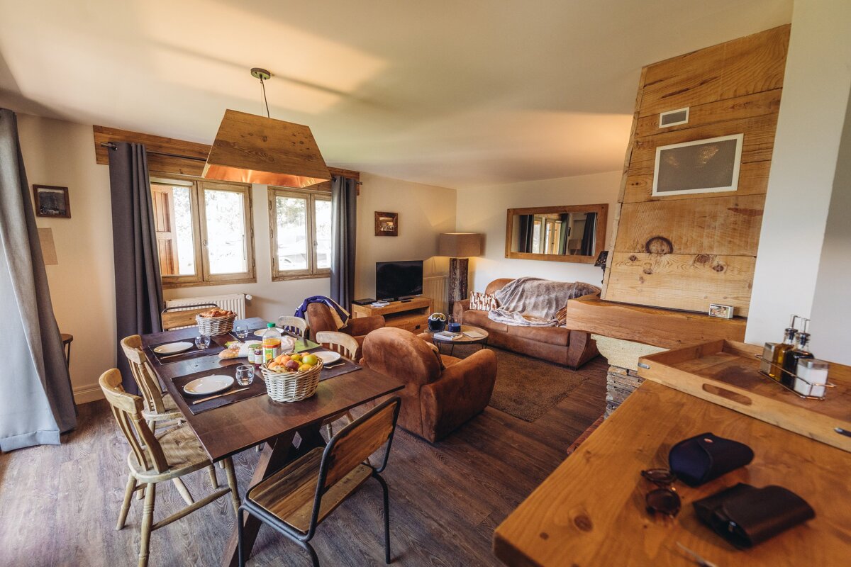 A living room with a dining table and chairs