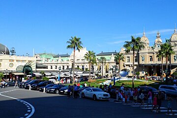 Expensive cars and people crossing the road