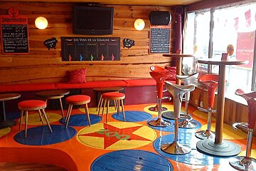 A sign on the wall says les vins de la semaine