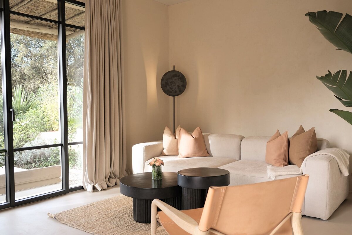 A living room with a couch and two tables