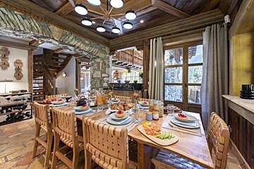 A dining room table with plates of food on it