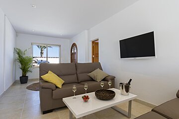 A living room with a couch and a flat screen tv