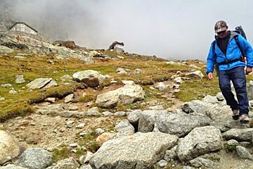 a man walking away from a mountain hut in chamonix