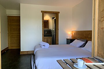 A bedroom with two beds and a book on a table