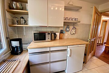 A kitchen with a microwave and a coffee maker