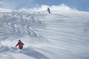 two skiers off piste in deep snow