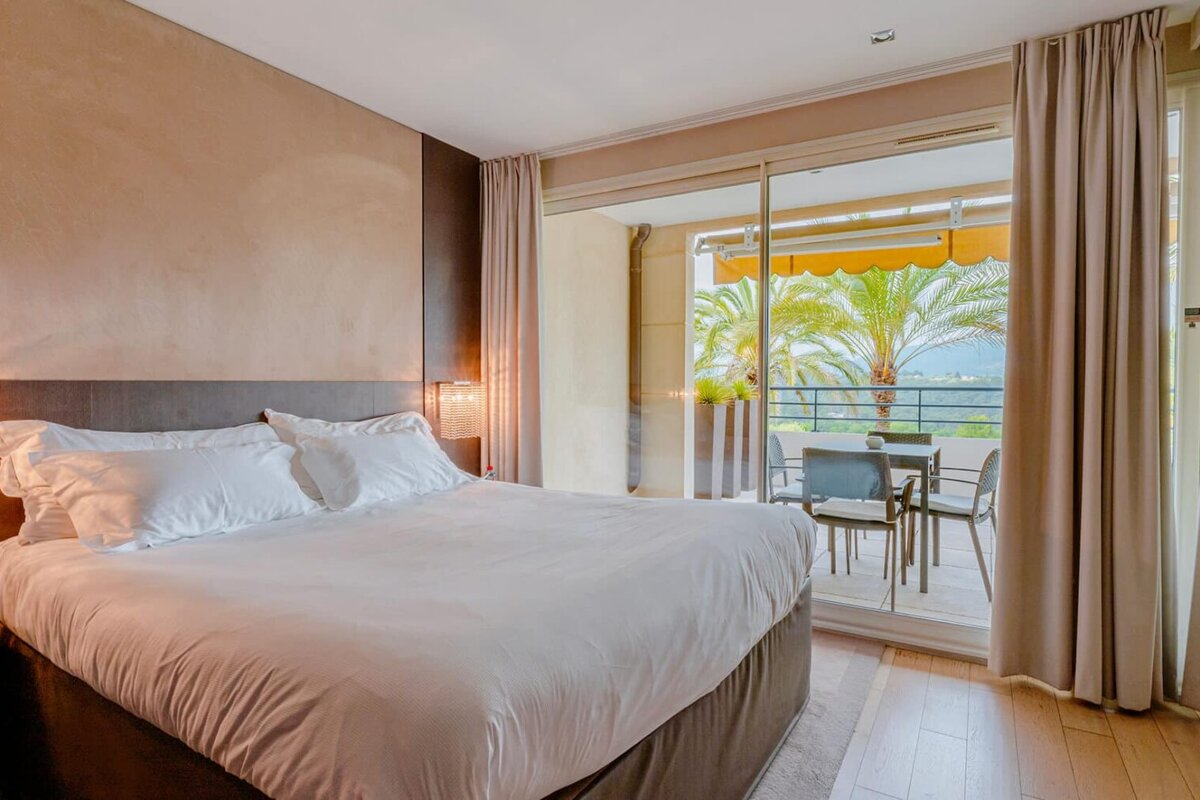 A hotel room with a large bed and a balcony