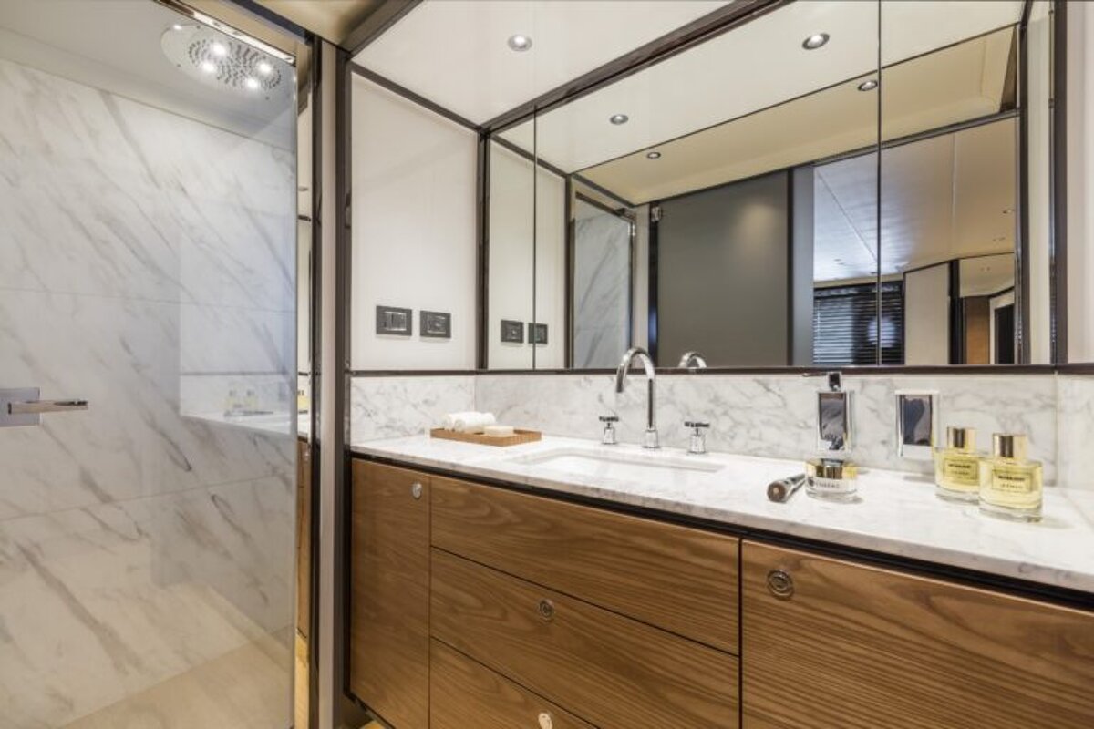 A bathroom with two bottles of chanel perfume on the counter