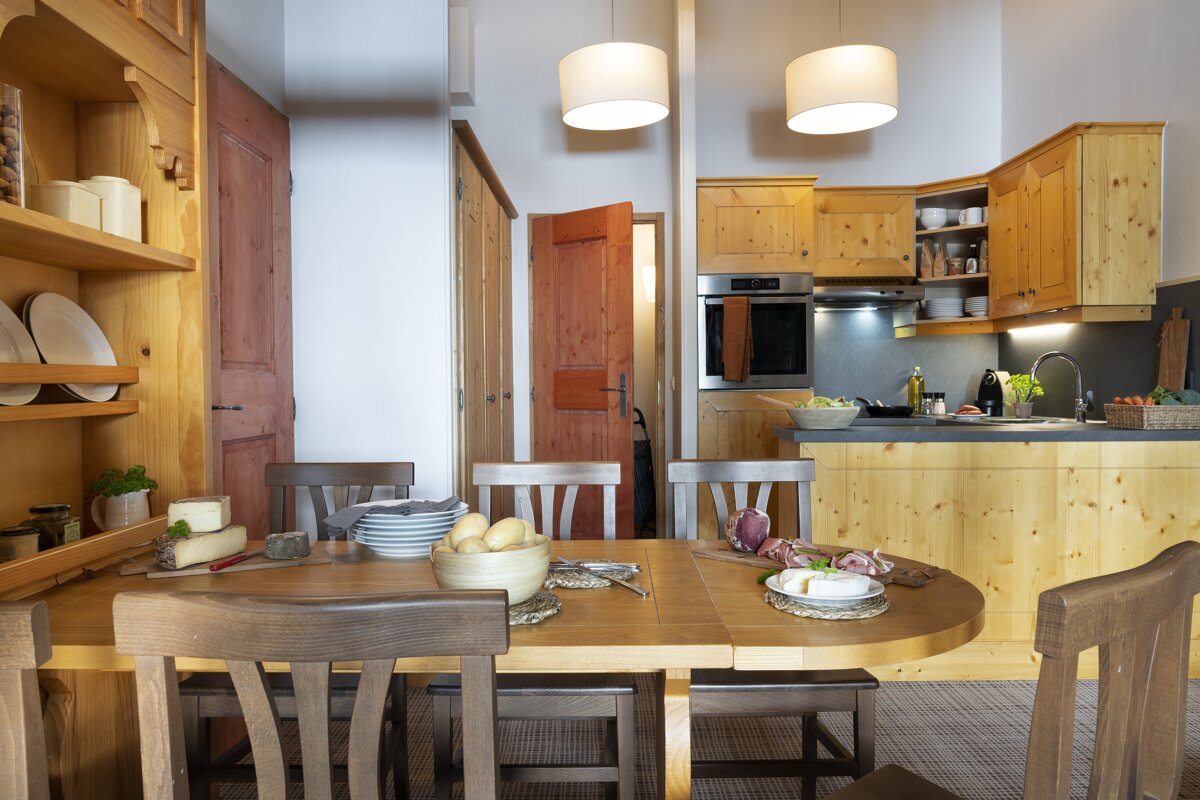 A dining room table with a bowl of potatoes on it