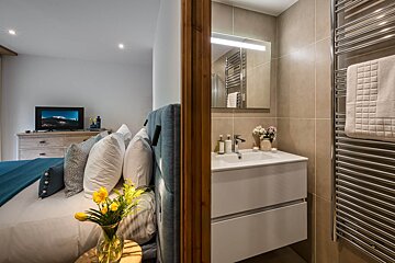 A bathroom with a sink and a towel rack