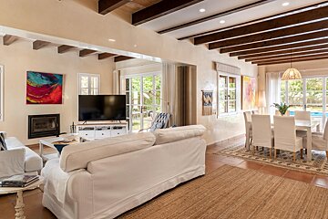 A living room with white furniture and a flat screen tv