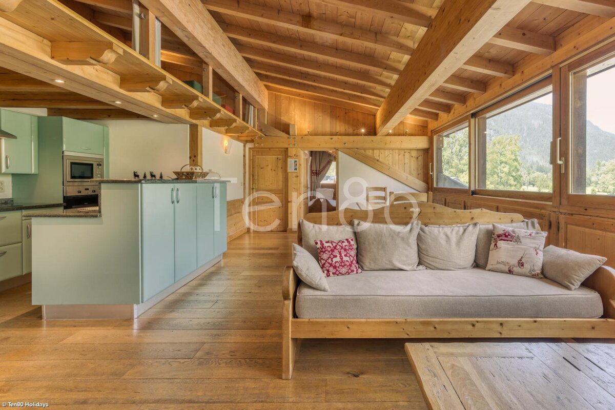 A living room with a couch and a sign that says ' eric holiday ' on it