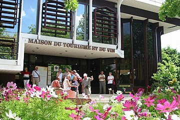 the exterior of the building with pink flowers