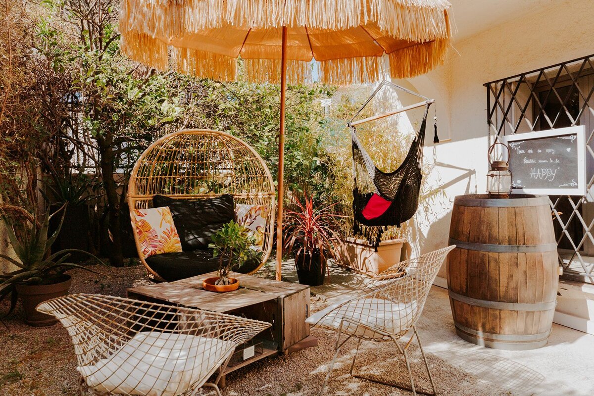 A patio with a hammock and a sign that says happy