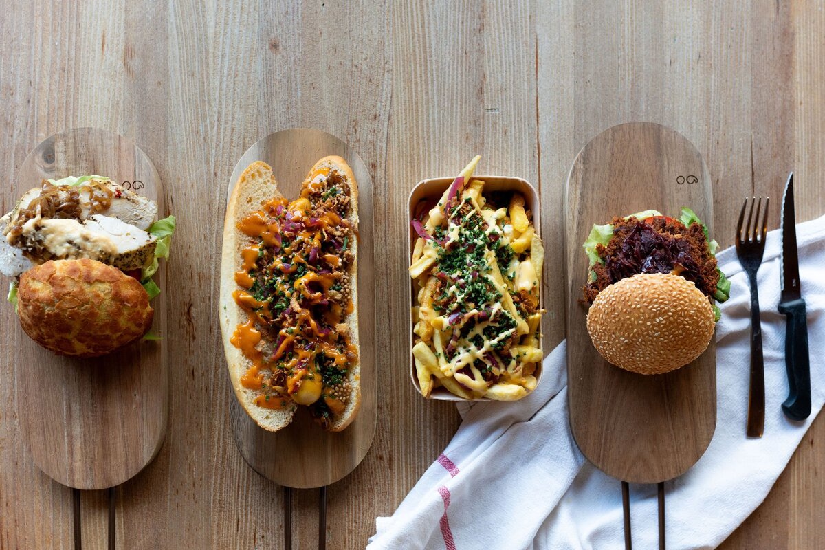 A bunch of food including a hot dog french fries and a hamburger