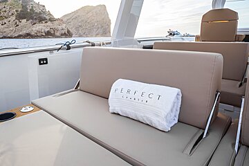 A perfect charter towel sits on the back of a boat