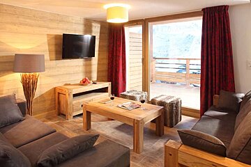 A living room with a couch a table and a flat screen tv