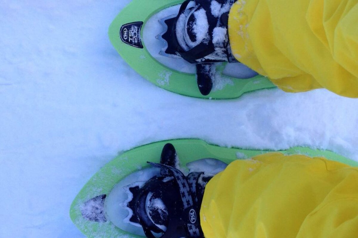 someone in yellow pants and snow shoes