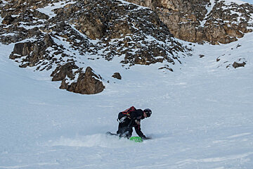a snowboarder in a couloir