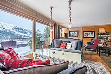 A living room with a couch and a pillow that says home sweet home